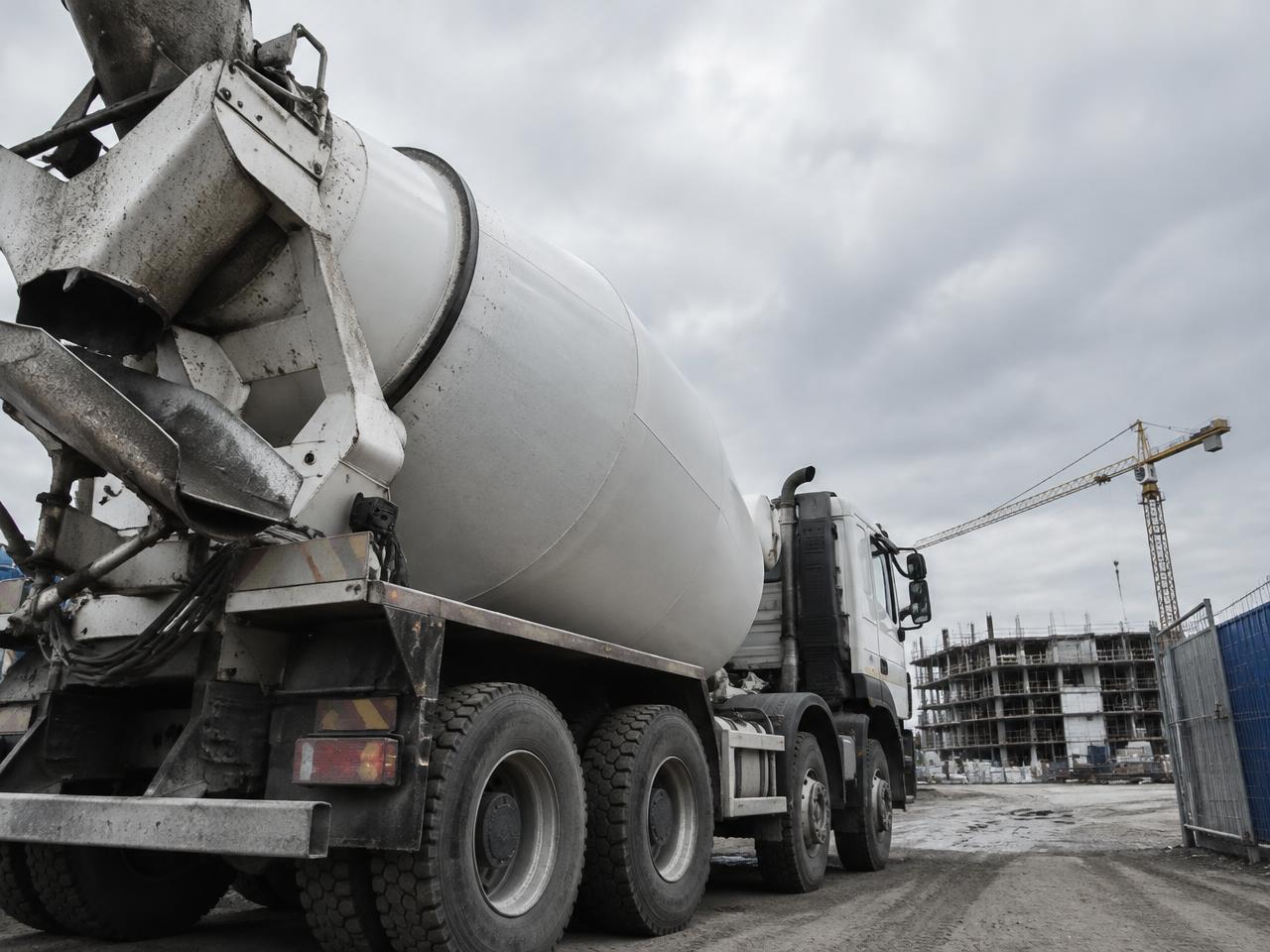 Concrete mixer truck at a site entrance (representative image)